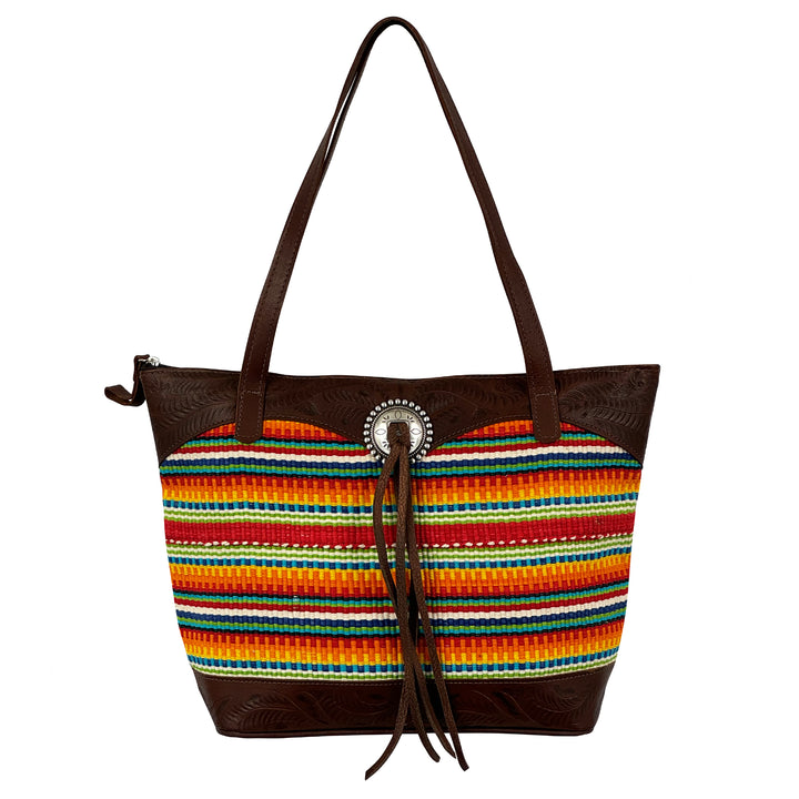 Maká Festive tote in brown with hand tooled leather, red themed hand woven tapestry, and bolo concho with tassle shown with straps up