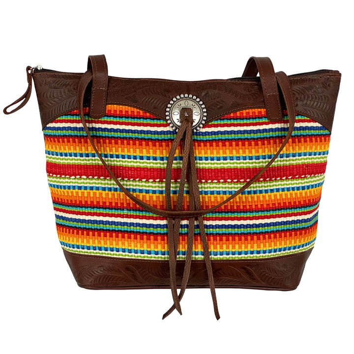 Maká Festive tote in brown with hand tooled leather, red themed hand woven tapestry, and bolo concho with tassle