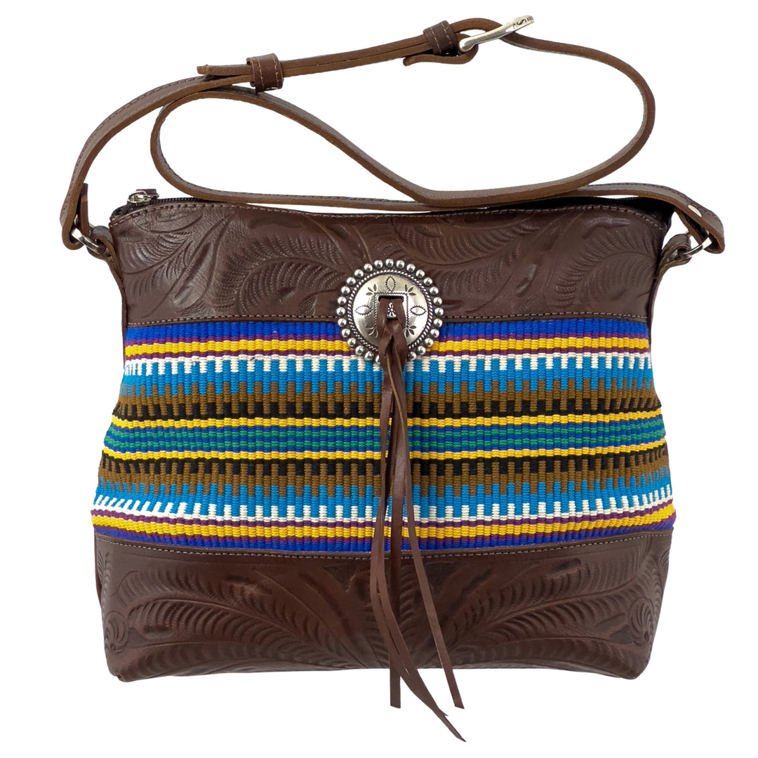 Maká Festive shoulder bag in brown with hand tooled leather, blue themed hand woven tapestry, and bolo concho with tassle
