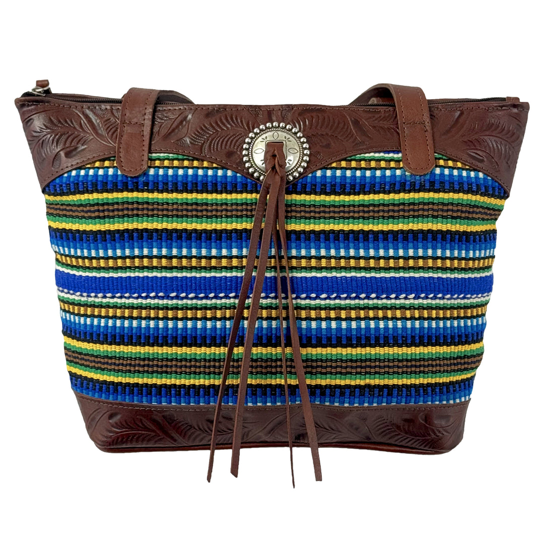 Maká Festive tote in brown with hand tooled leather, blue themed hand woven tapestry, and bolo concho with tassle