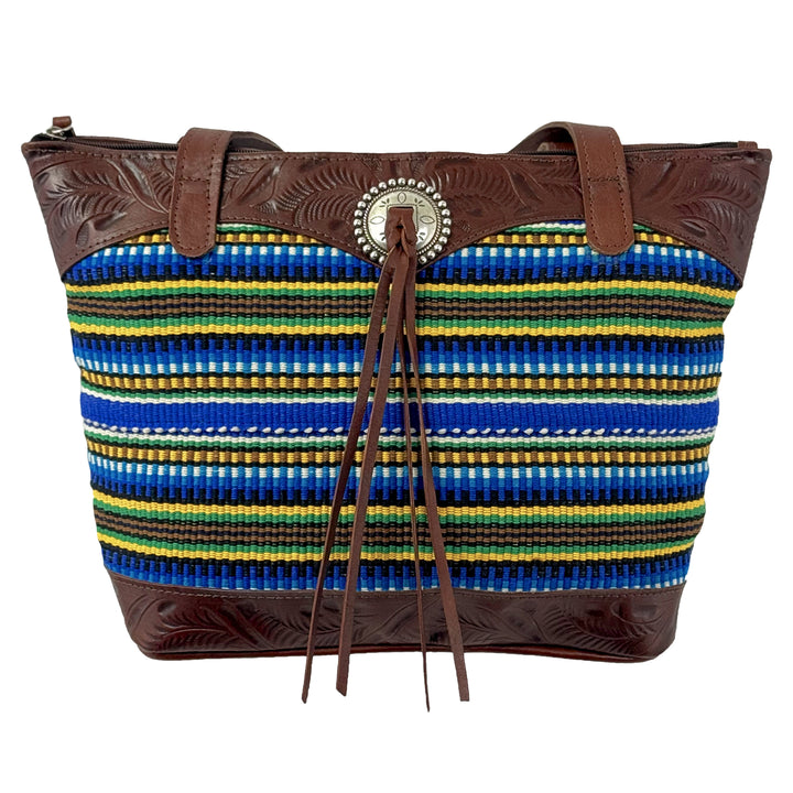 Maká Festive tote in brown with hand tooled leather, blue themed hand woven tapestry, and bolo concho with tassle
