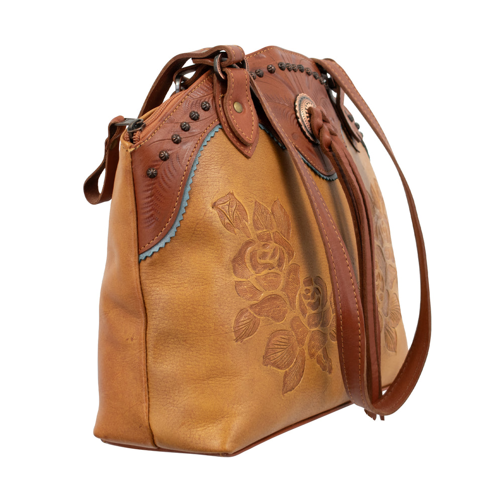 Side view of Texas Rose tote in natural tan with hand tooled leather accents and bolo concho with tassel