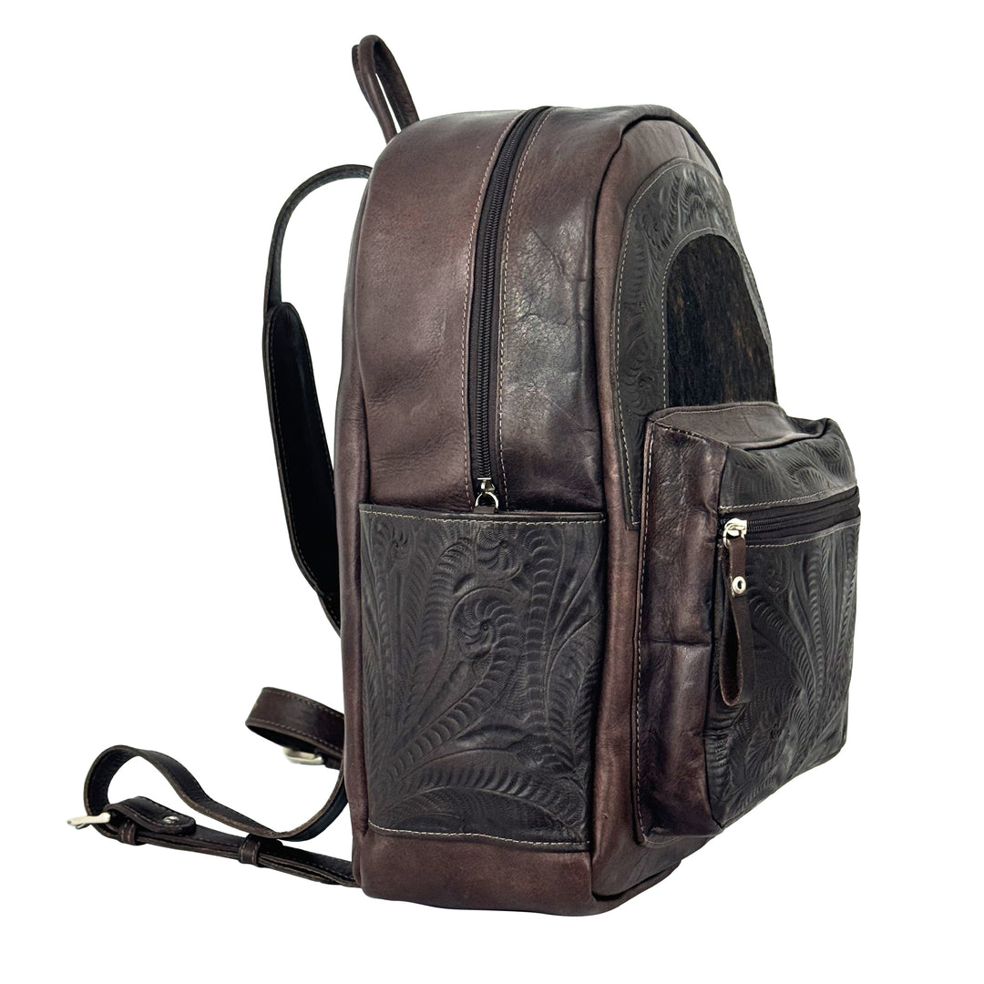 Side view of Classic Travel backpack with hair-on hide in dark brown with hair-on hide accent and hand tooled leather trim