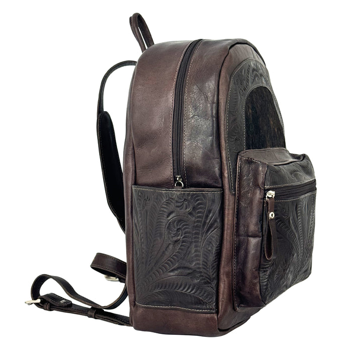Side view of Classic Travel backpack with hair-on hide in dark brown with hair-on hide accent and hand tooled leather trim