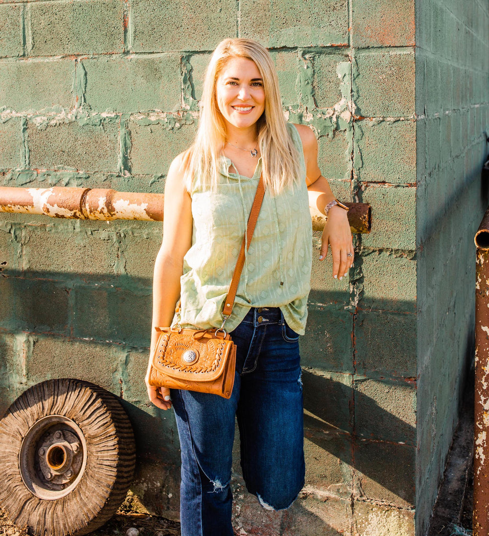 Lifestyle with model of Harvest Moon crossbody bag in natural tan with hand tooled leather accents