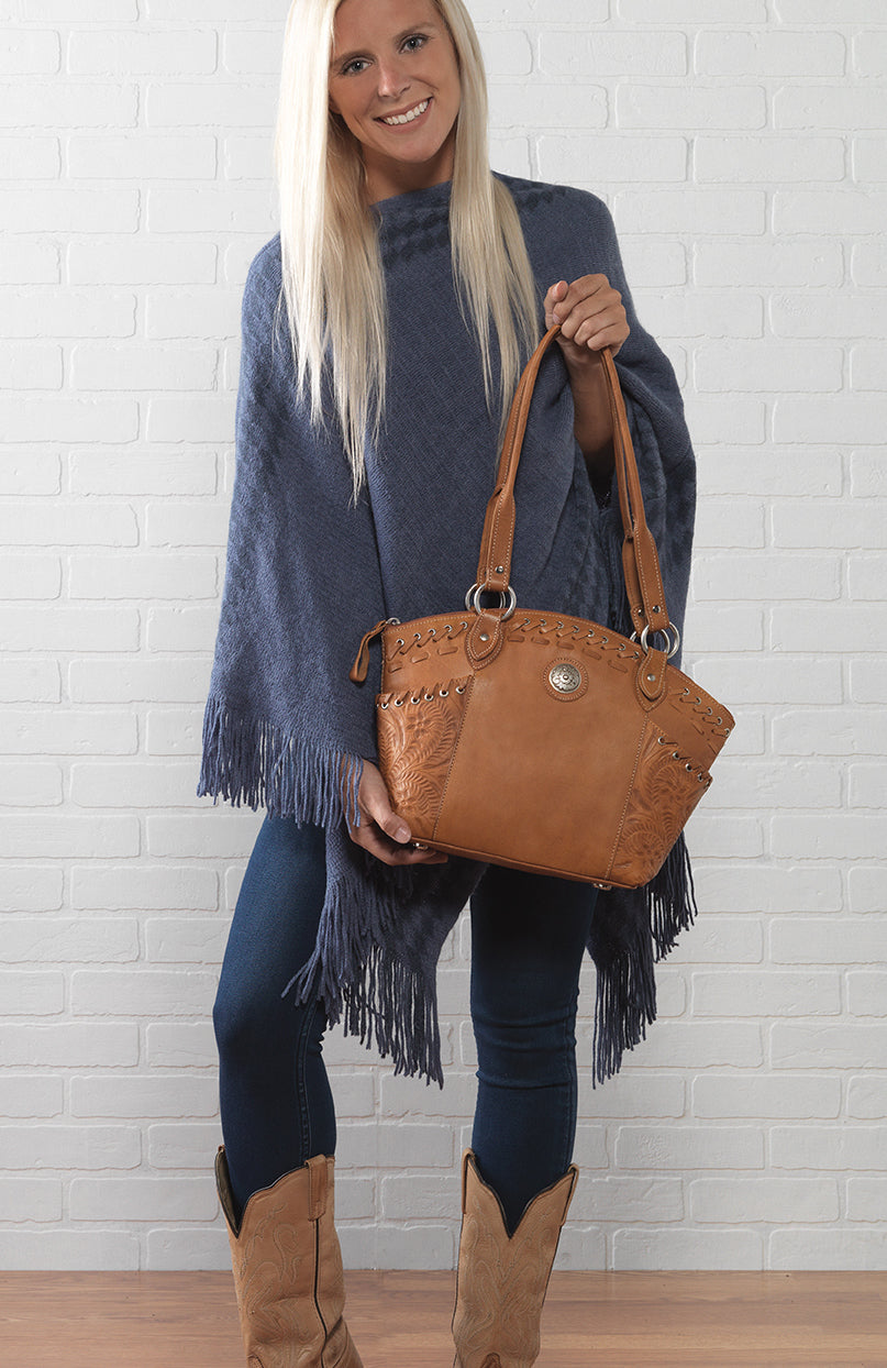 Lifestyle with model of Harvest Moon bucket tote in natural tan with hand tooled leather accents