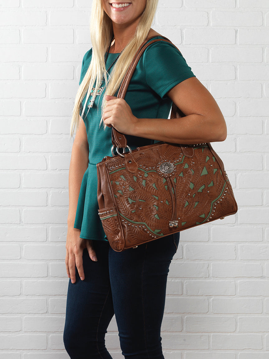 Lifestyle with model of Lady Lace multi-compartment organizer tote in medium brown with hand tooled leather and cut out accents