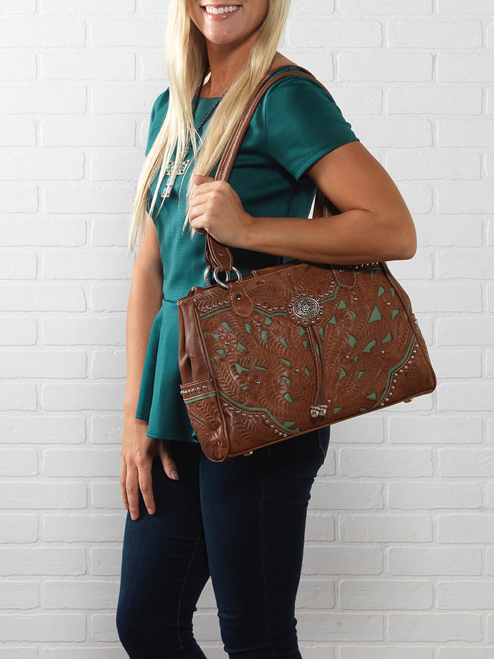 Lifestyle with model of Lady Lace multi-compartment organizer tote in medium brown with hand tooled leather and cut out accents